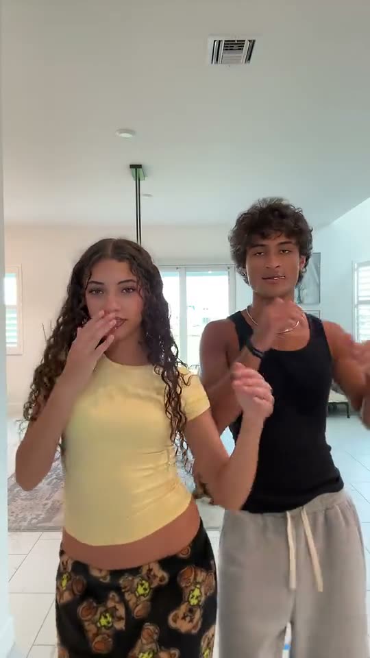 Abra Kadabra trend: a dancer in a yellow top starts alone as a dog wanders by, then her friend in black appears beside her