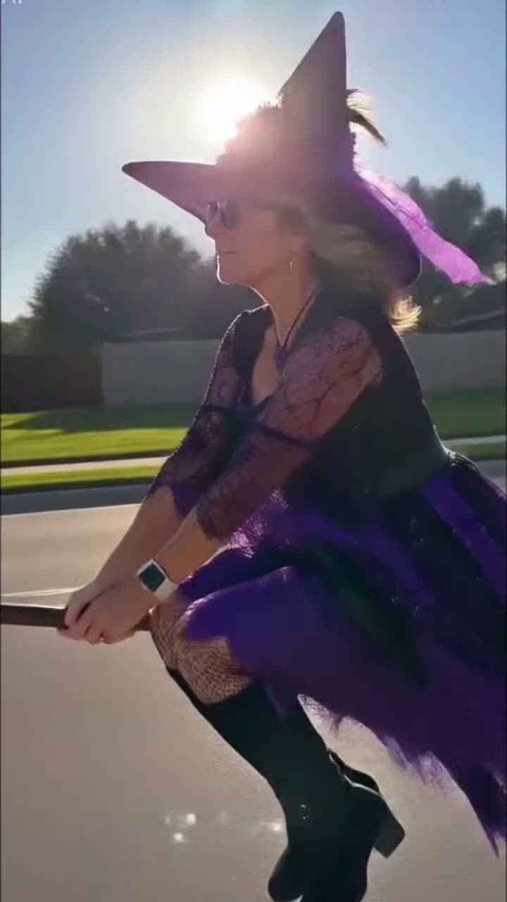 Flying broom AI crash: a witch flies into a stop sign and lands on the sidewalk