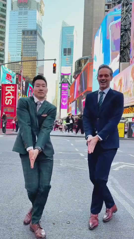 Nicole Kidman dance: two men in suits do the dance side by side on a city square