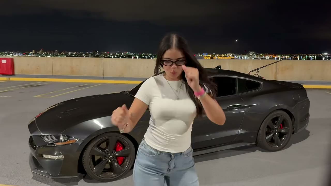 Unforgettable 24 car trend: she swipes the cards and her Mustang GT appears on a rooftop parking deck