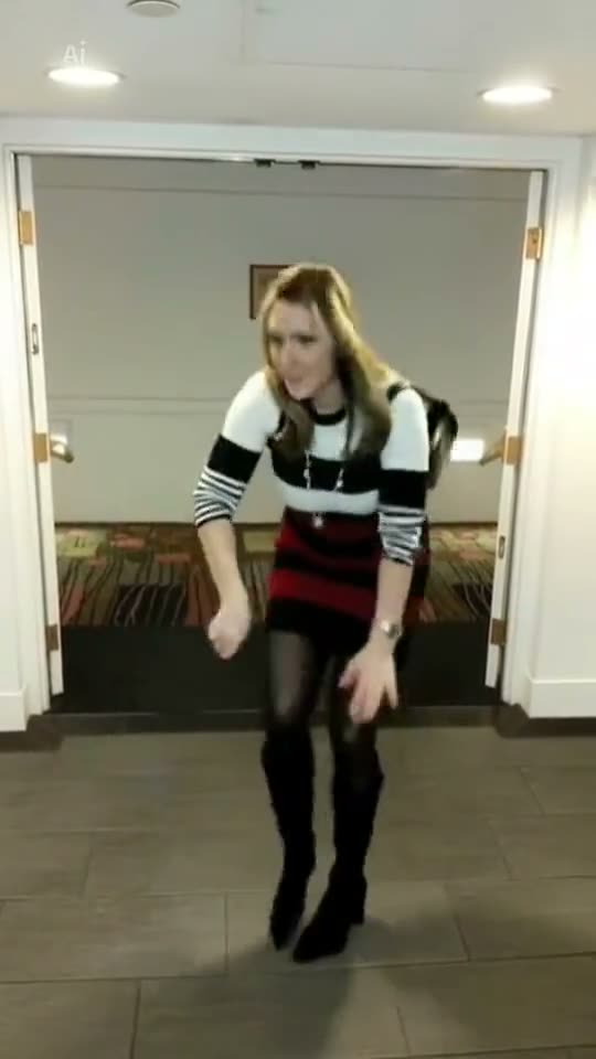 Wipe Me Down AI: a woman in a striped top and a red skirt does the Wipe Me Down dance in a hallway